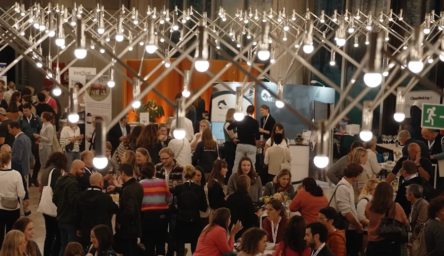 A sponsor stand at ESER displaying equine veterinary equipment with posters in the background.